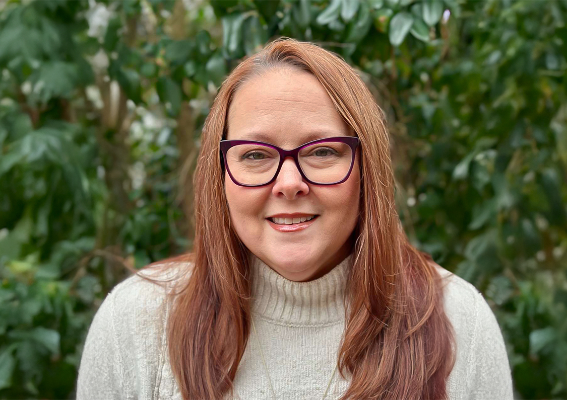 a woman wearing glasses and a turtleneck sweater