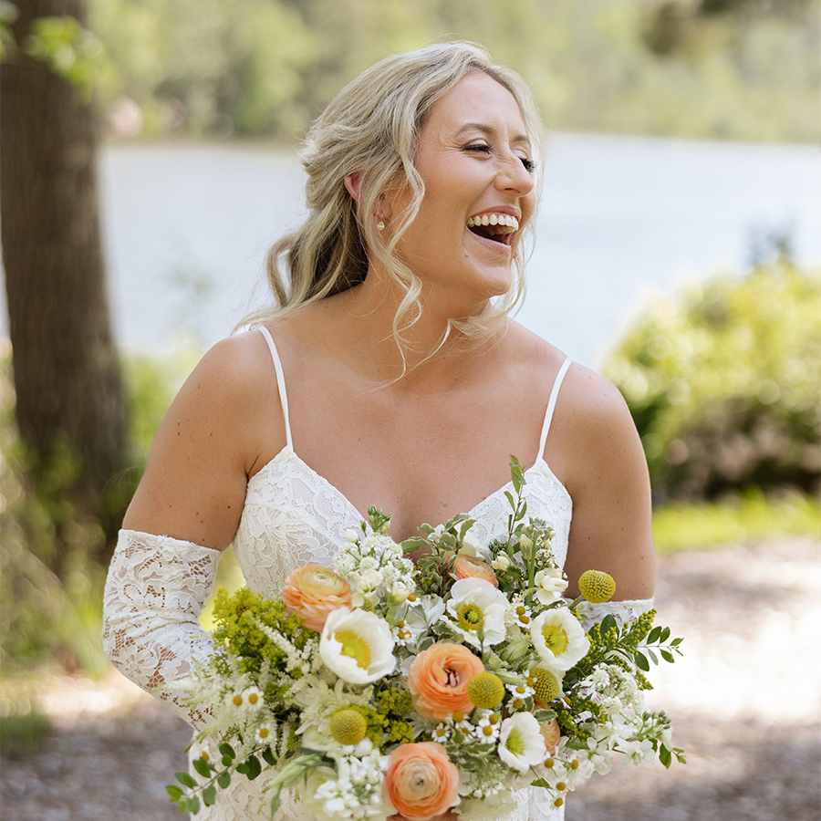 a woman in a white dress holding a bouquet of flowers