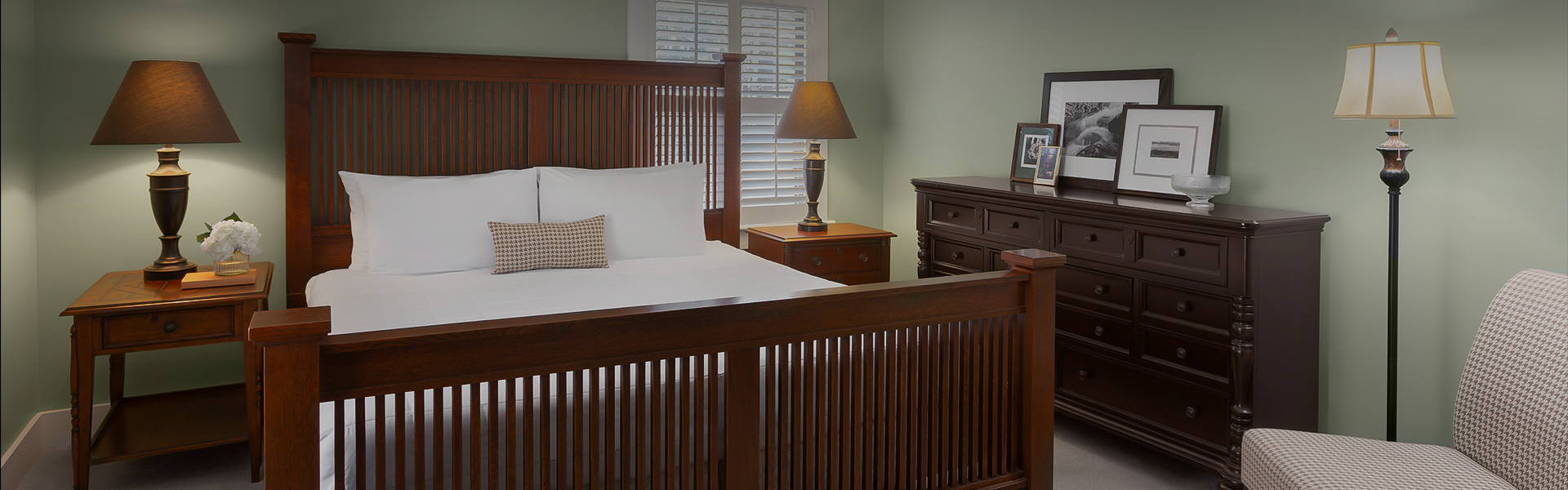 a bedroom with a bed and a lamp