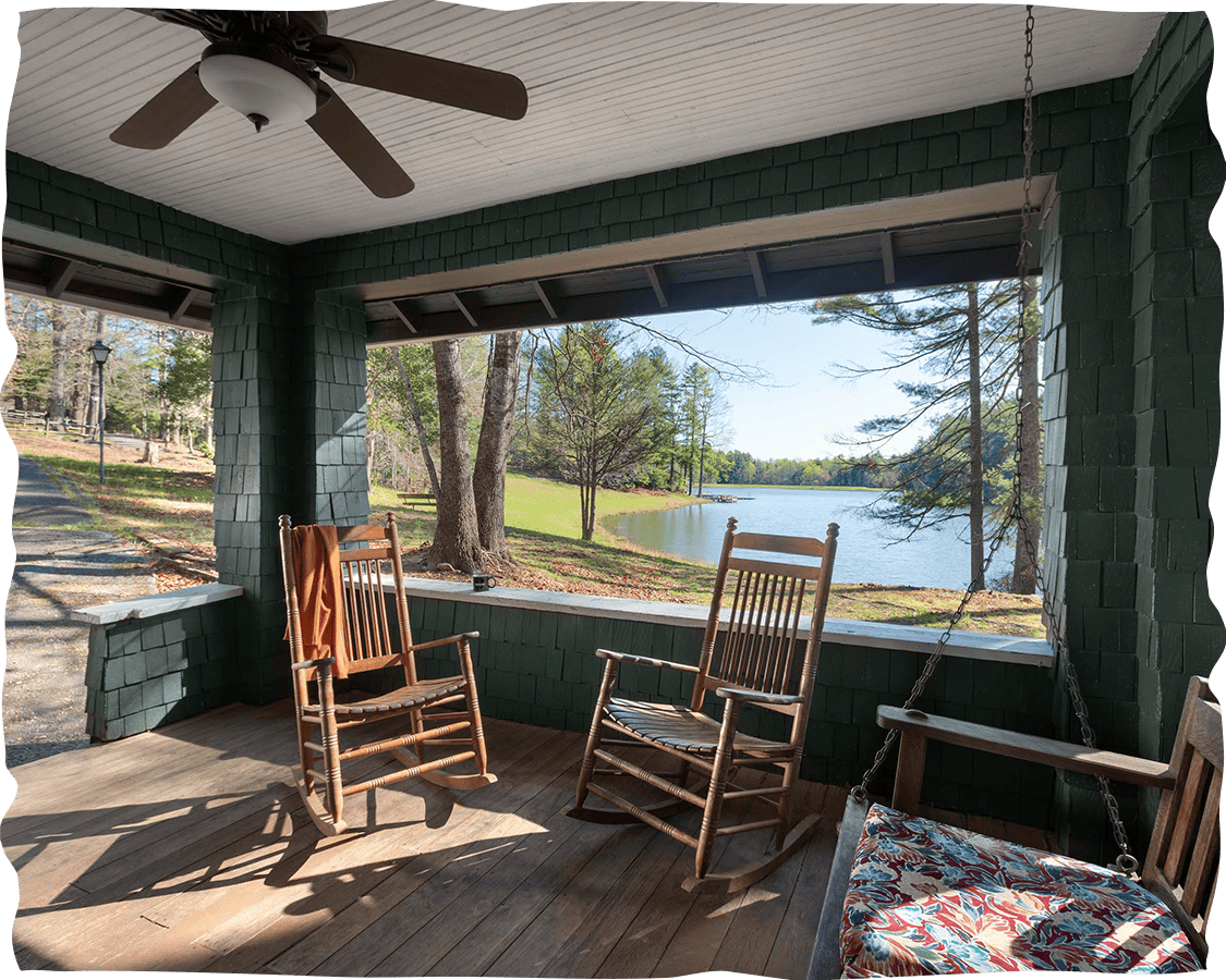 a porch with rocking chairs and a fan