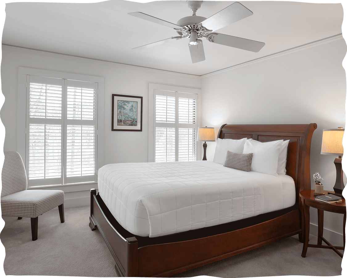 a bedroom with a bed and a fan