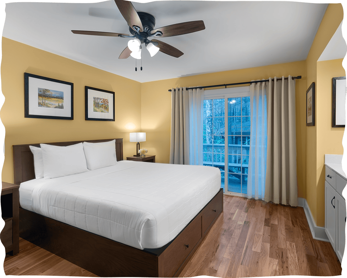 a bedroom with a bed and a ceiling fan
