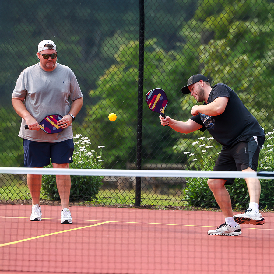 two men playing tennis on a court