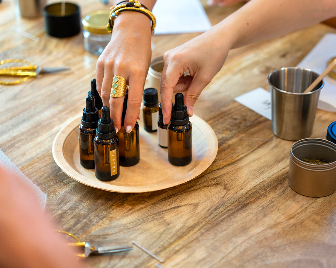 a person holding bottles of essential oils