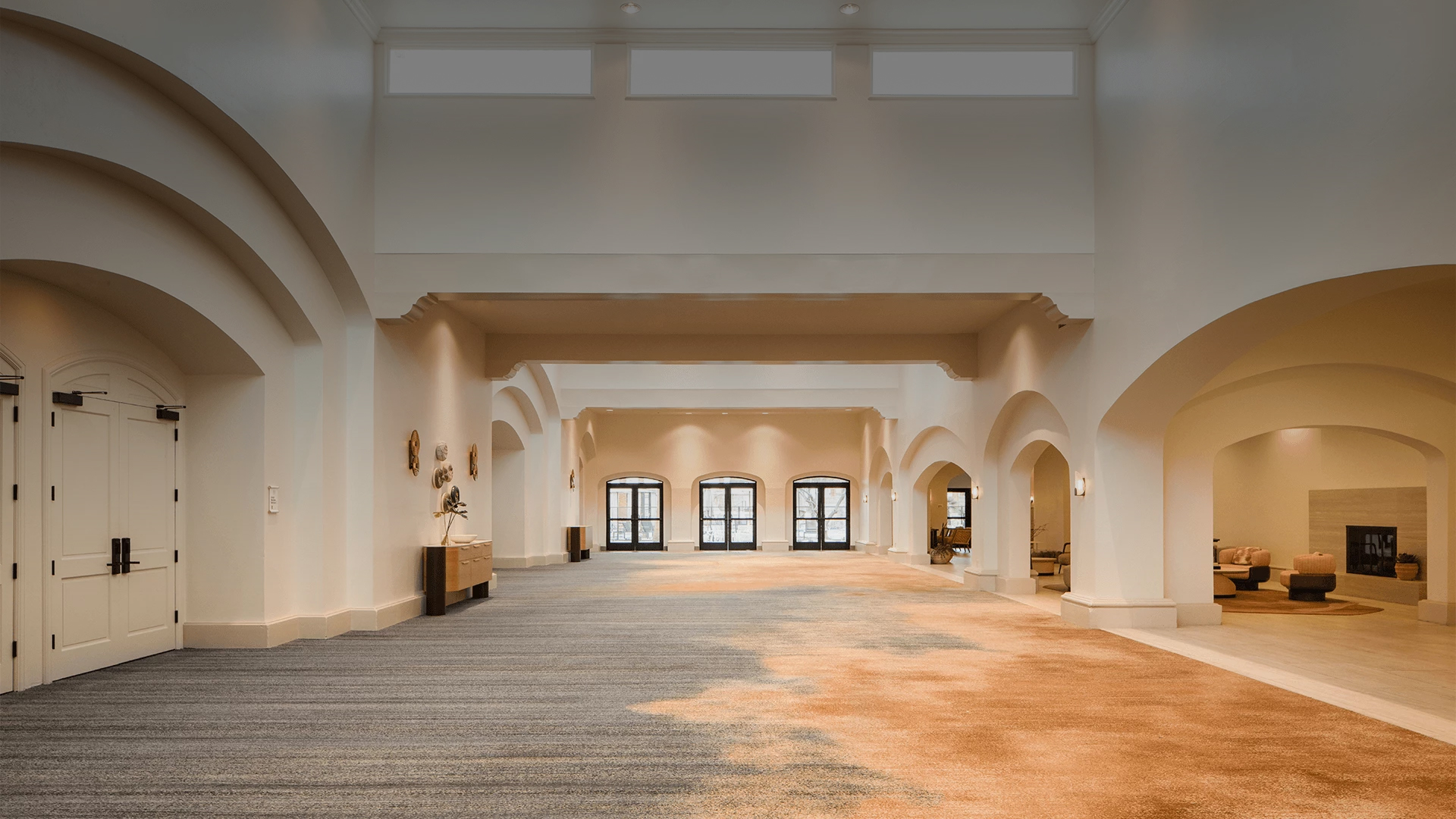 a large room with arched walls and carpet