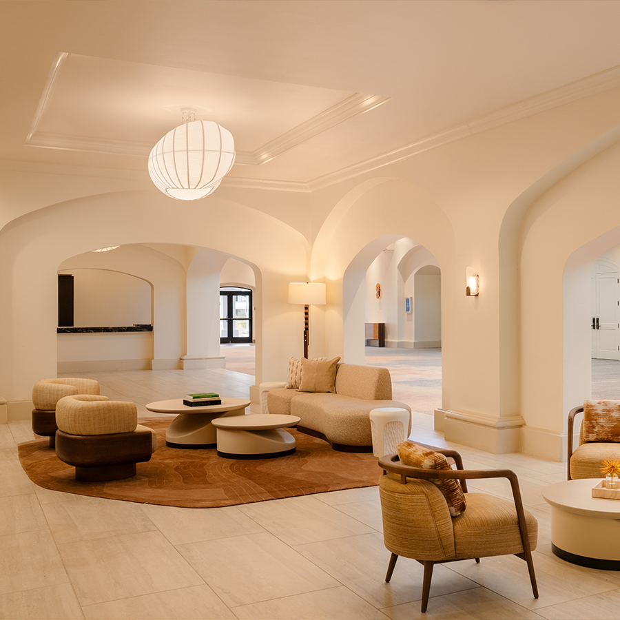 a room with white walls and a white floor with a round table and chairs