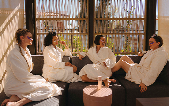 a group of people in white robes sitting on a couch