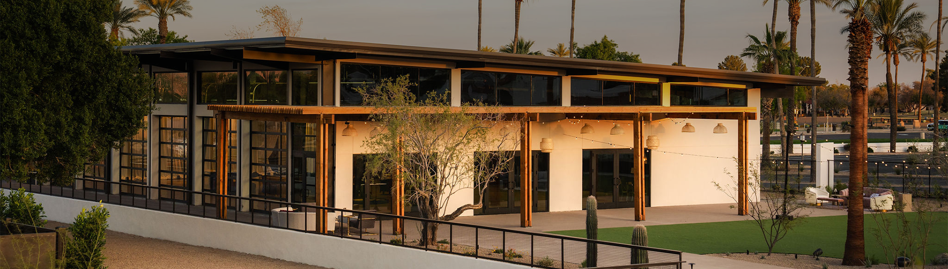a building with a cactus and trees