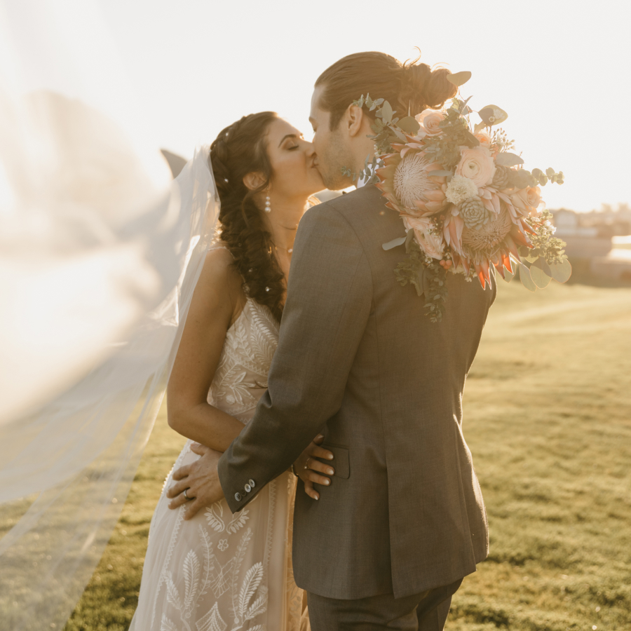 a man and woman kissing in a field