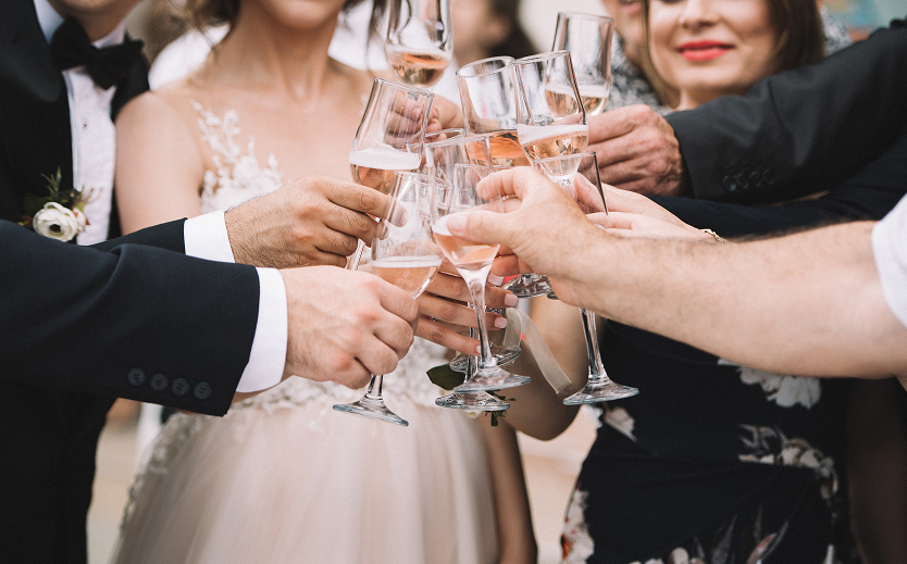 a group of people clinking wine glasses