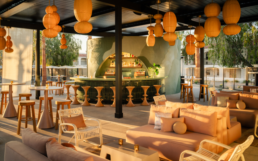 a patio with a bar and chairs