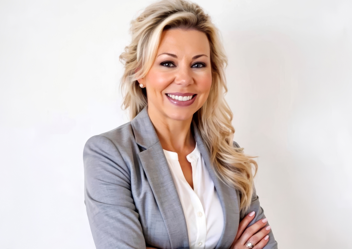 a woman with blonde hair wearing a grey suit