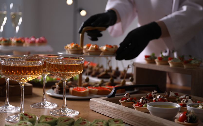a person putting food on a tray