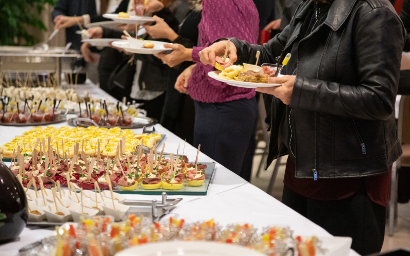 a group of people holding plates of food