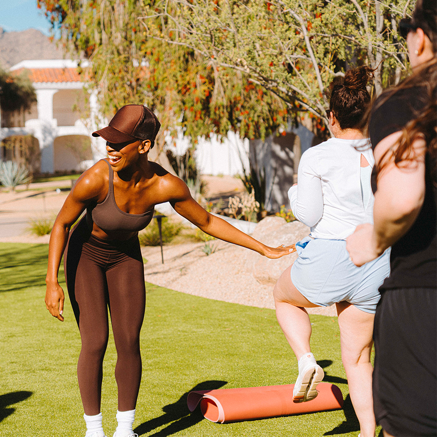 a woman standing on grass with other people