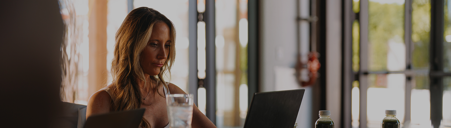 a woman looking at a laptop