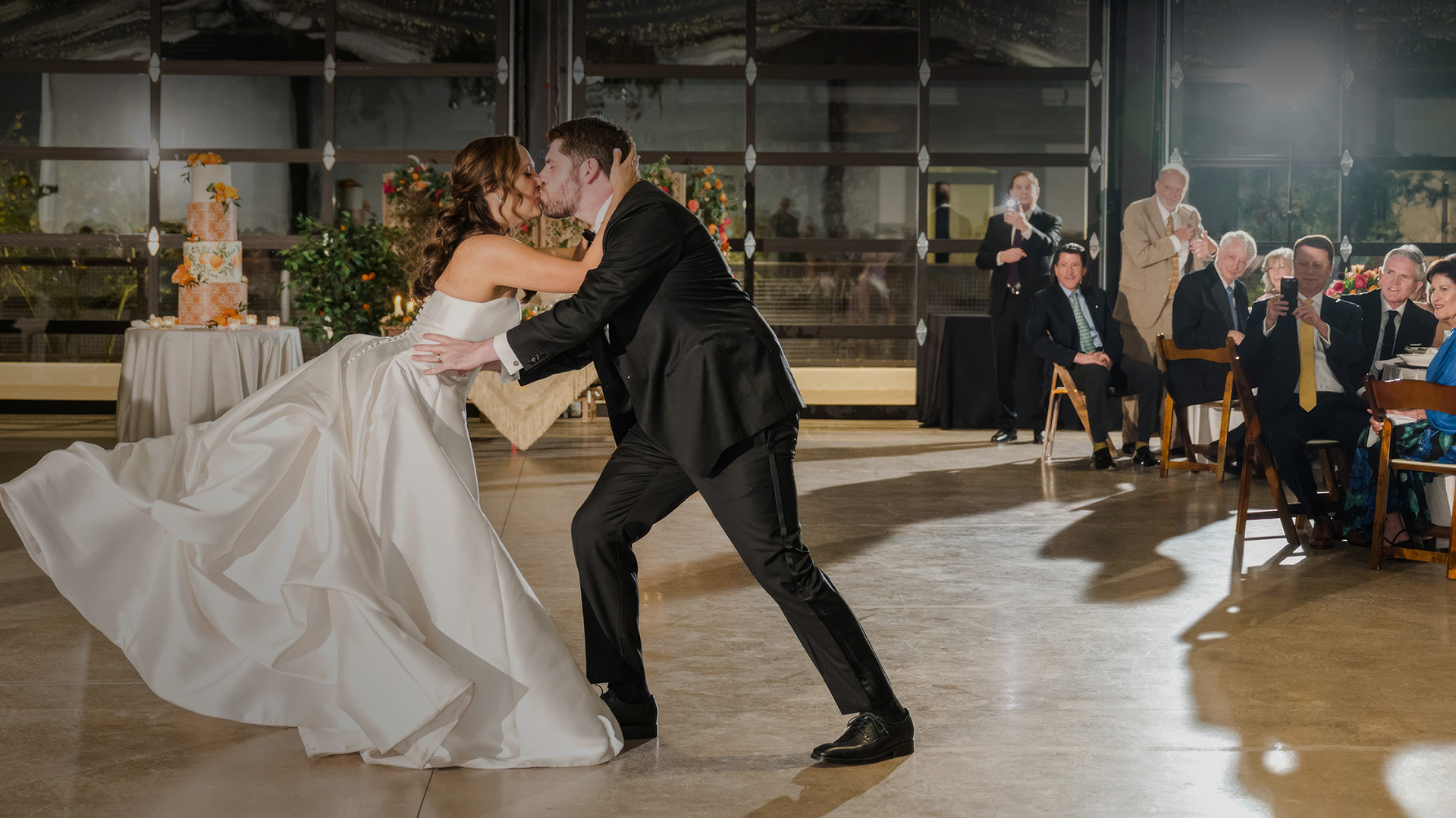a man and woman kissing on a dance floor