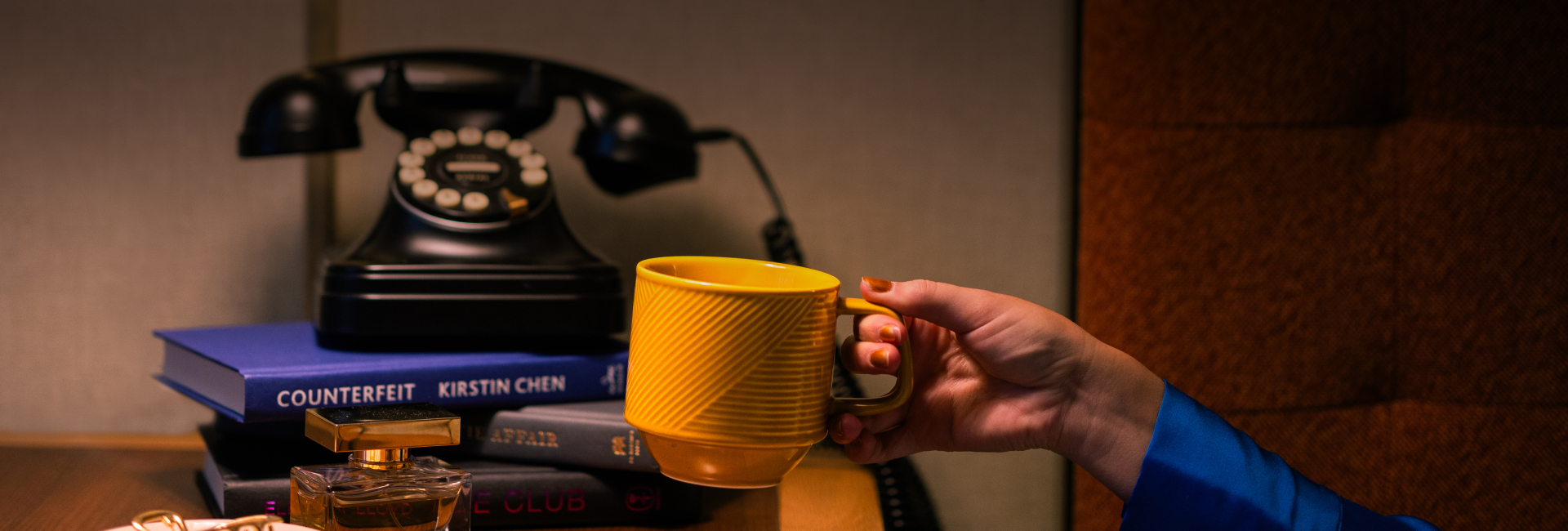 a person holding a yellow coffee cup