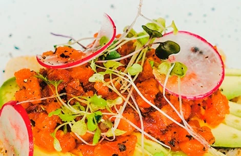 a plate of food with radish and sprouts