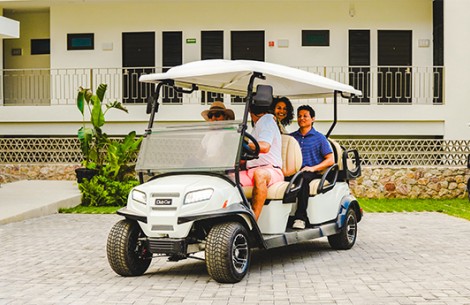 a group of people in a golf cart