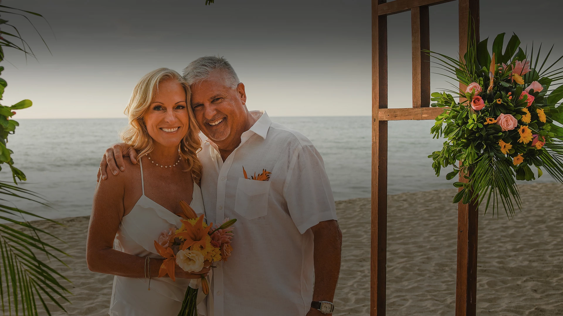 a man and woman standing on a beach