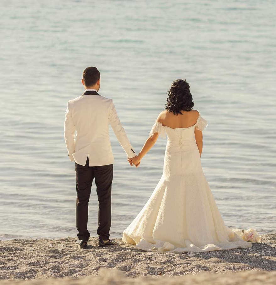 a man and woman holding hands on a beach
