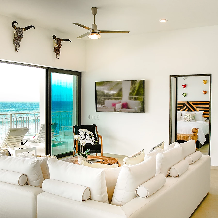 a room with a couch and a view of the ocean