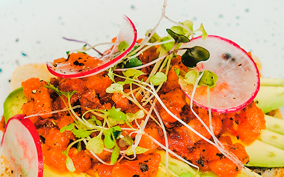 a plate of food with radish and sprouts