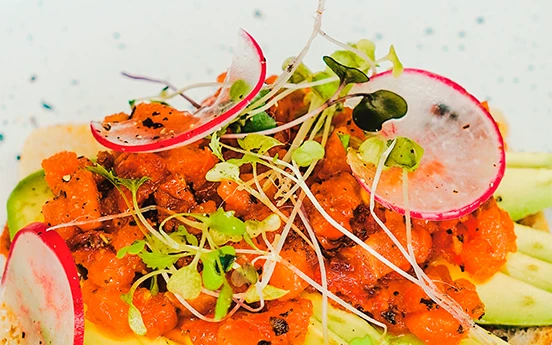 a plate of food with radish and sprouts