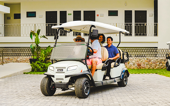 a group of people in a golf cart
