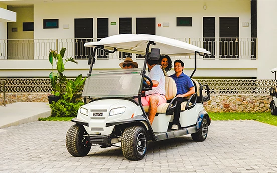 a group of people in a golf cart