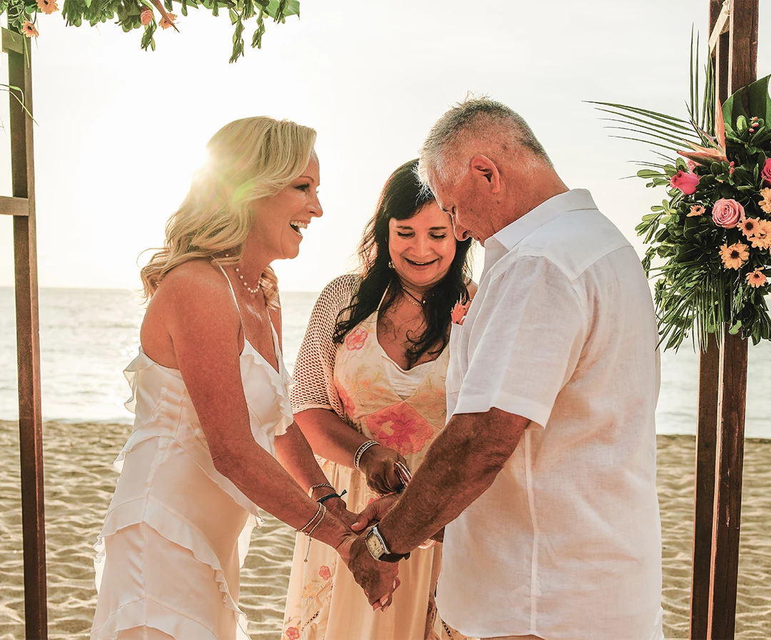 a group of people holding hands on a beach