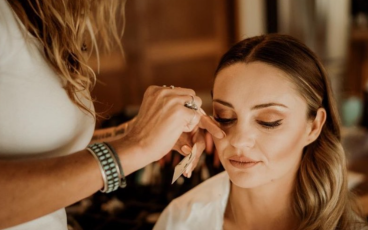 a woman getting her makeup done