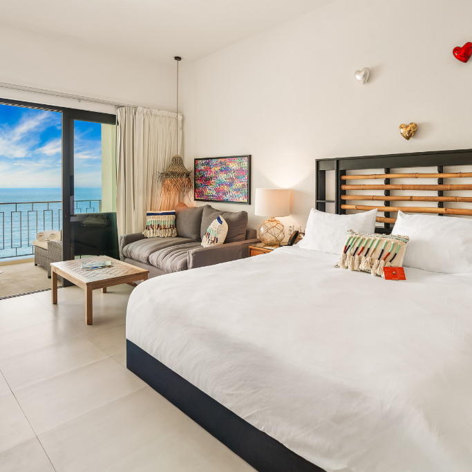 a bedroom with a large bed and a couch