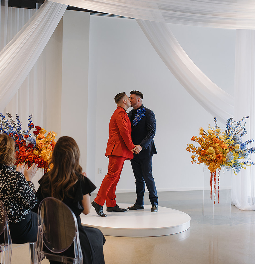 two men kissing on a stage