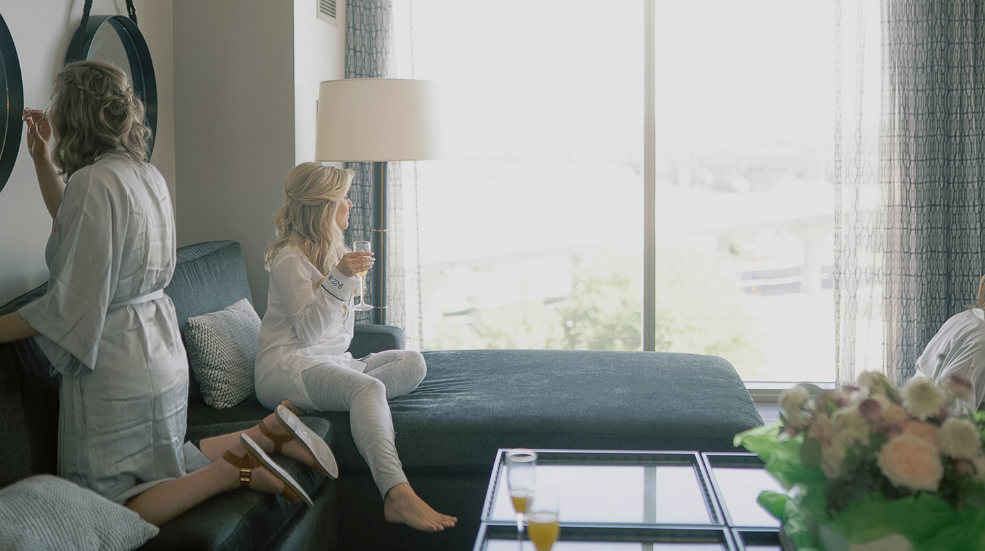 a woman sitting on a couch drinking wine