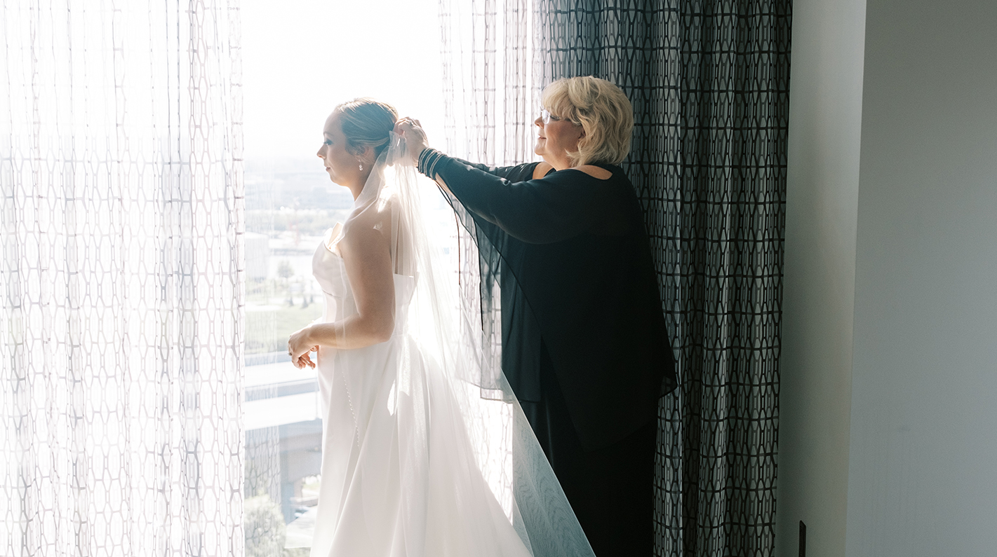 a woman putting on a veil