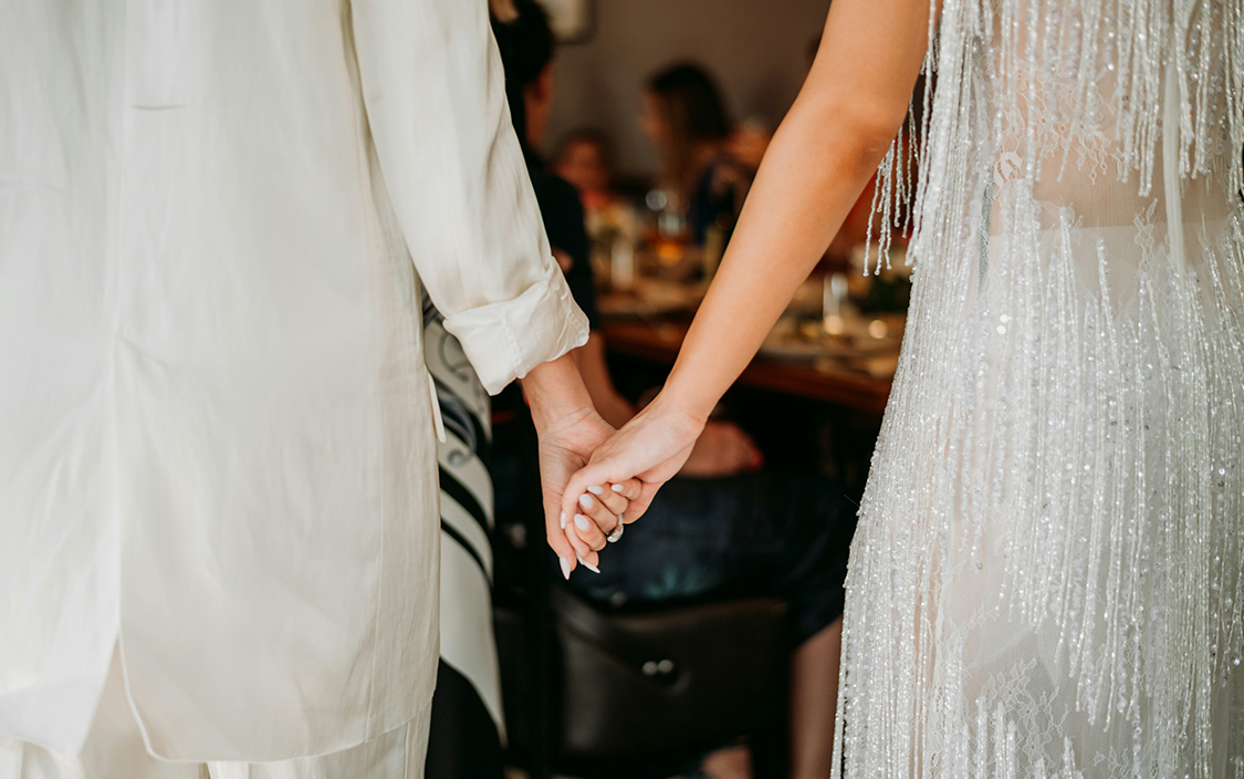 a couple holding hands in a room