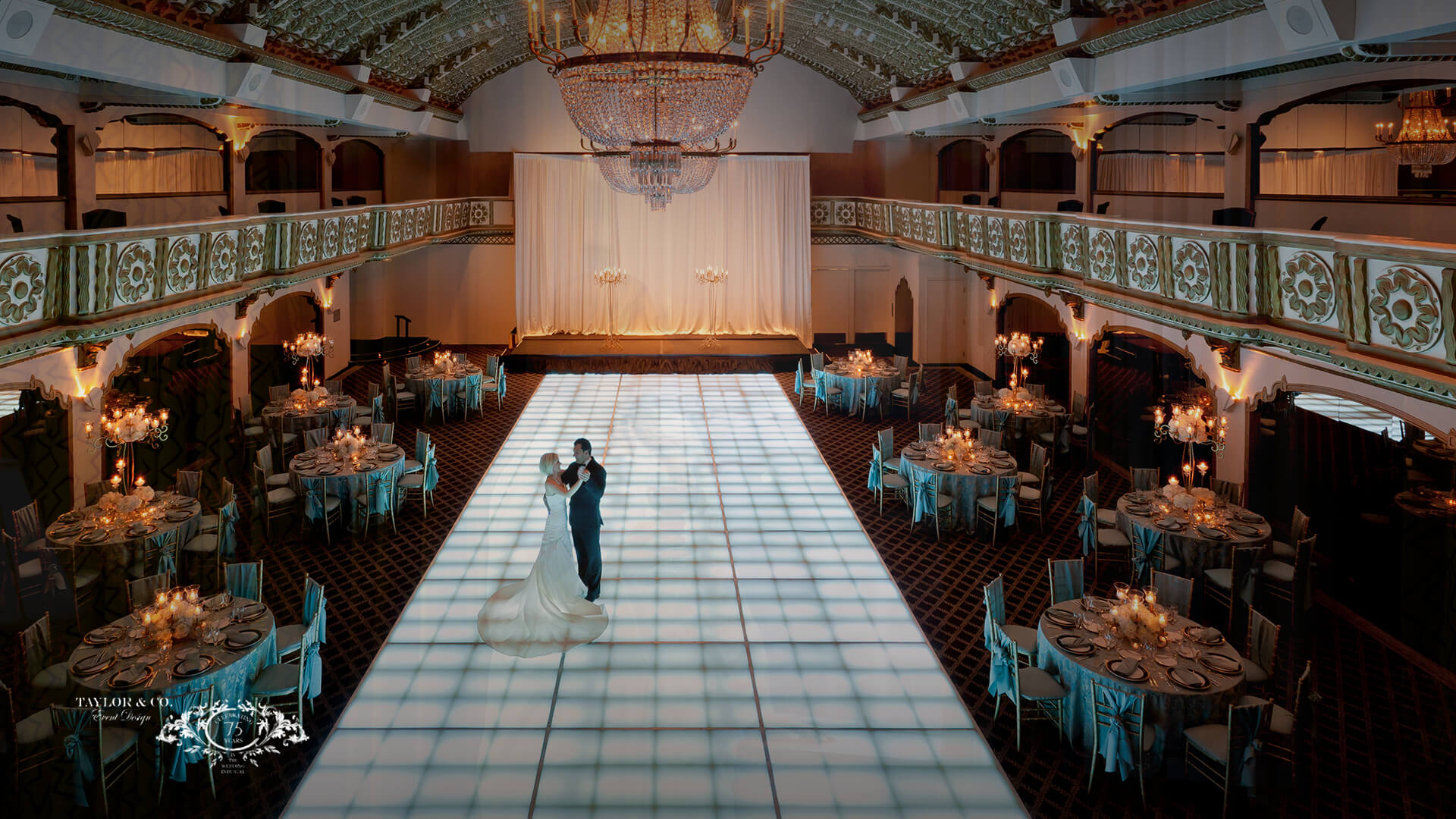 a man and woman dancing in a room with tables and chairs