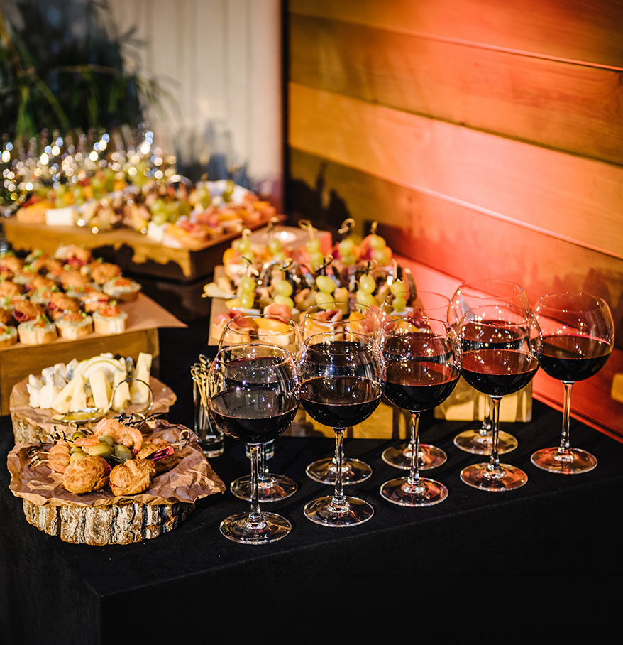 a table with wine glasses and snacks
