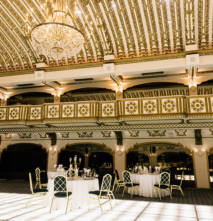 a room with a chandelier and tables