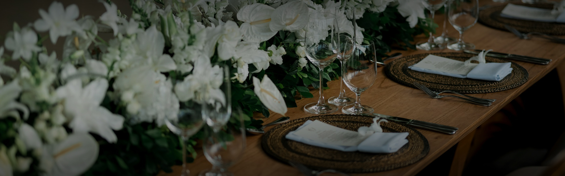 a table with wine glasses and flowers