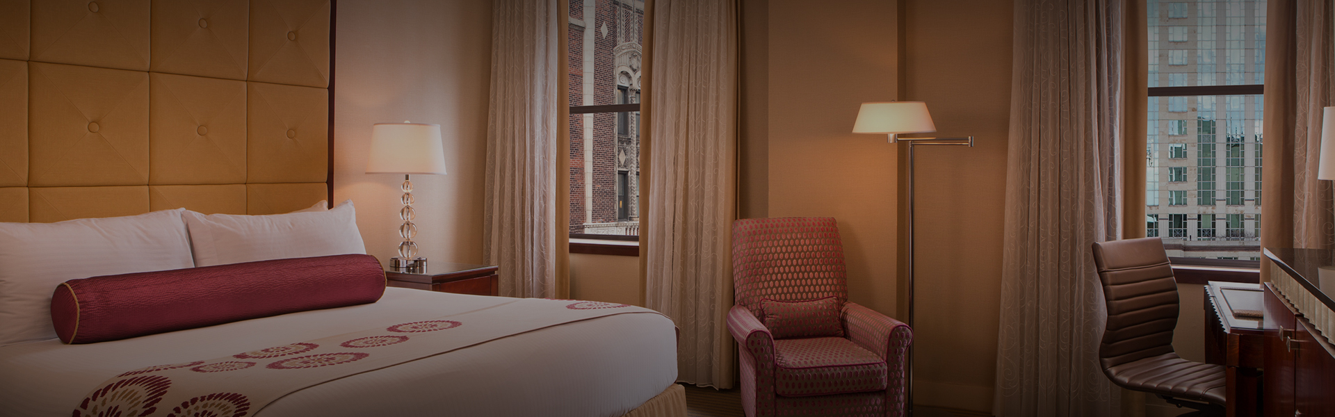 a bedroom with a bed and a lamp