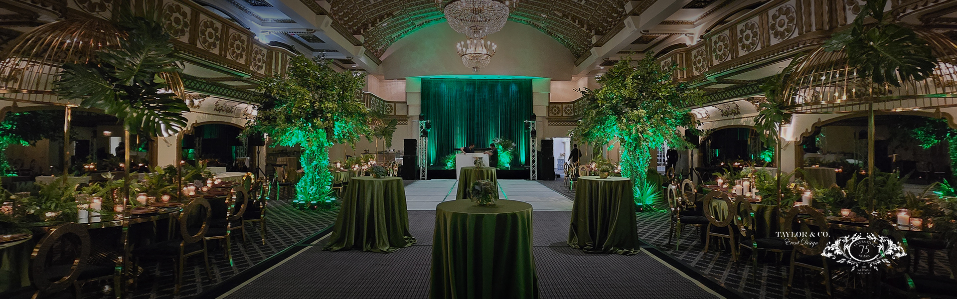 a green stage with tables and green curtains