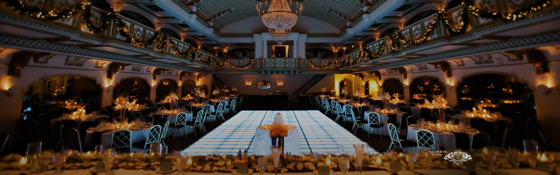a room with a dance floor and chandeliers