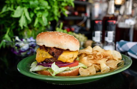 a cheeseburger and chips on a plate