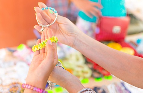 a close-up of hands holding bracelets