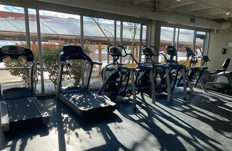 a group of exercise machines in a gym