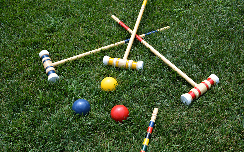 croquet mallets and balls on grass