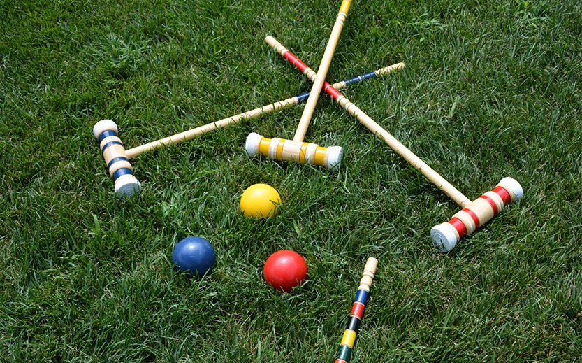croquet mallets and balls on grass